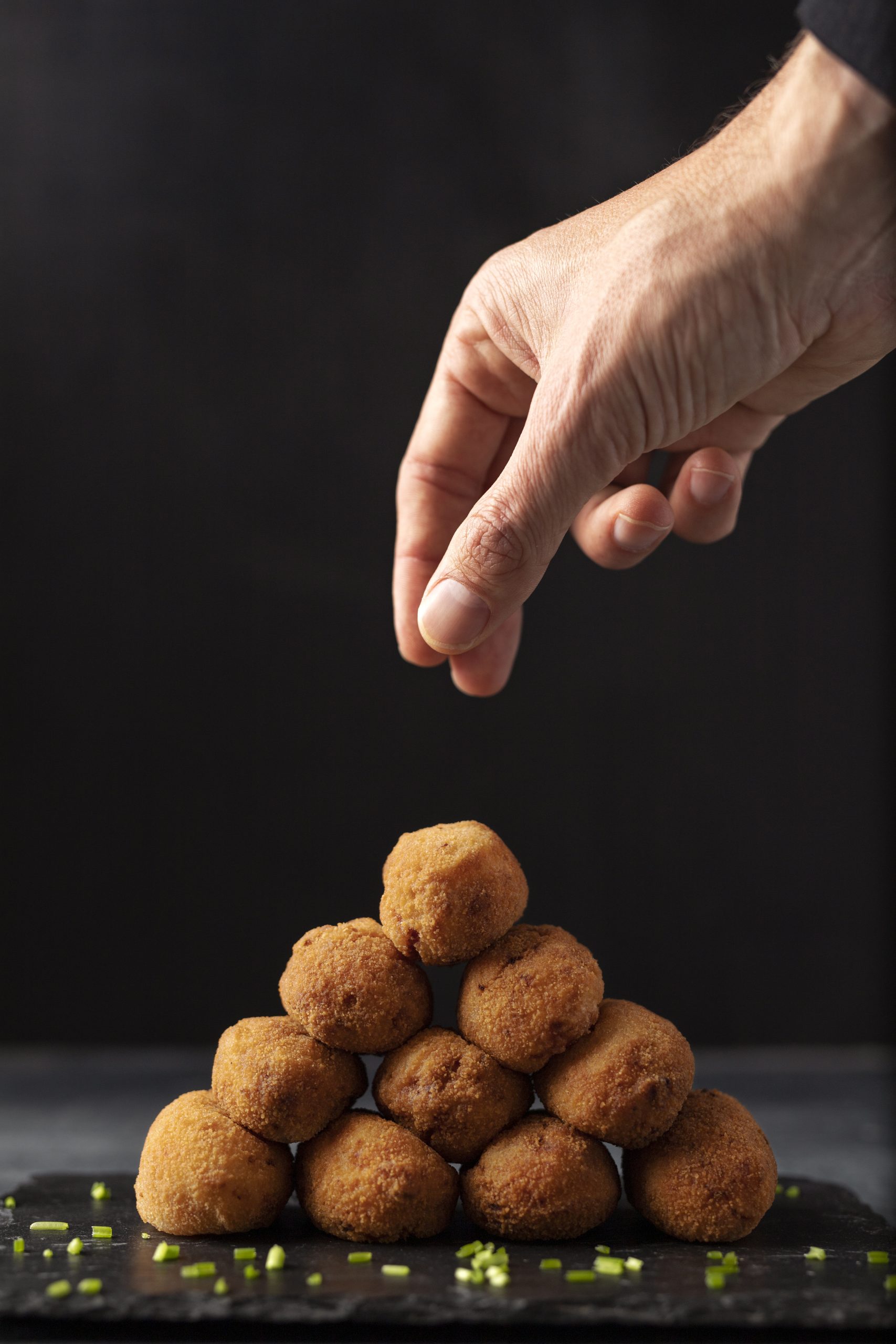 man-putting-salt-croquettes-with-parsley